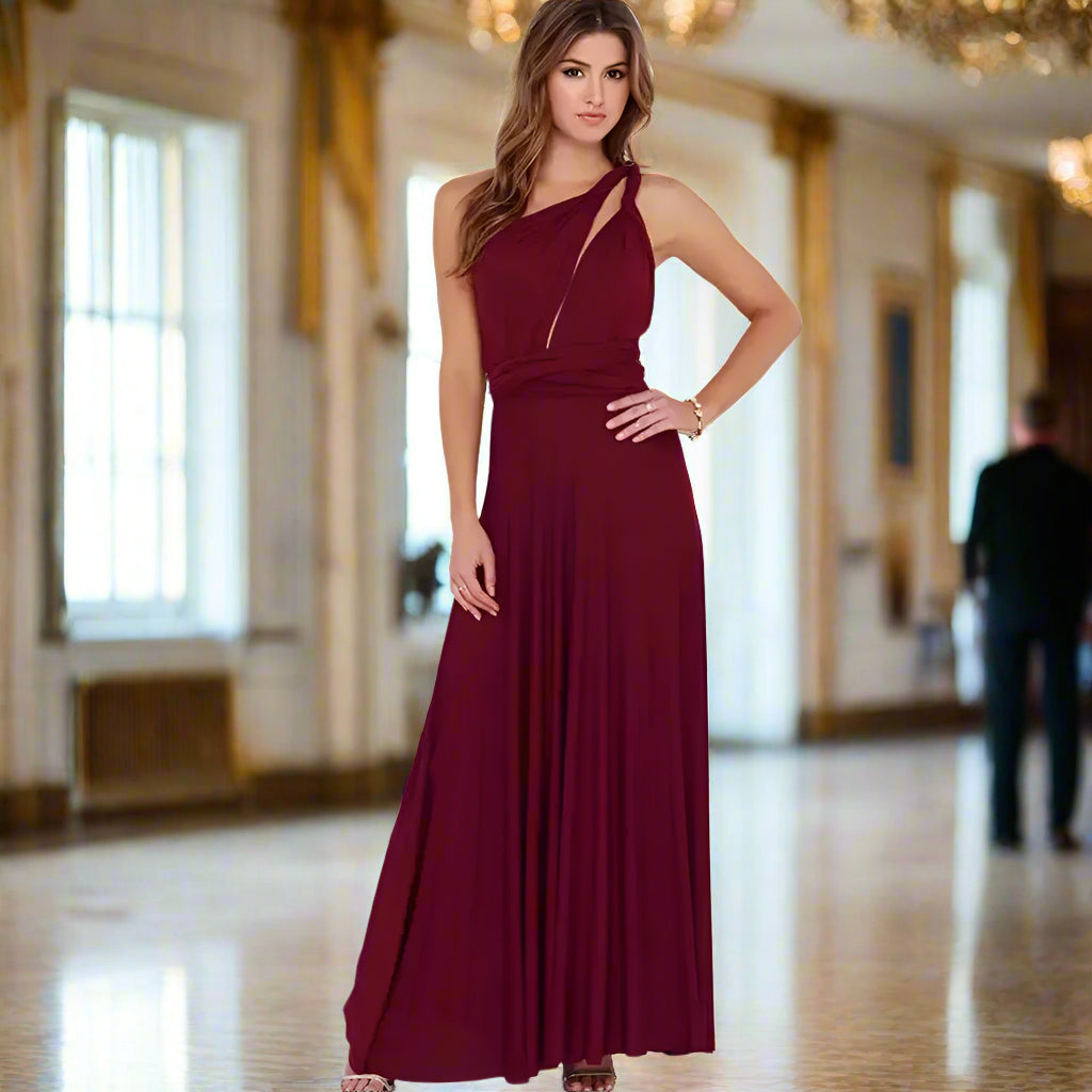 Woman wearing a burgundy halter neck gown against a white background