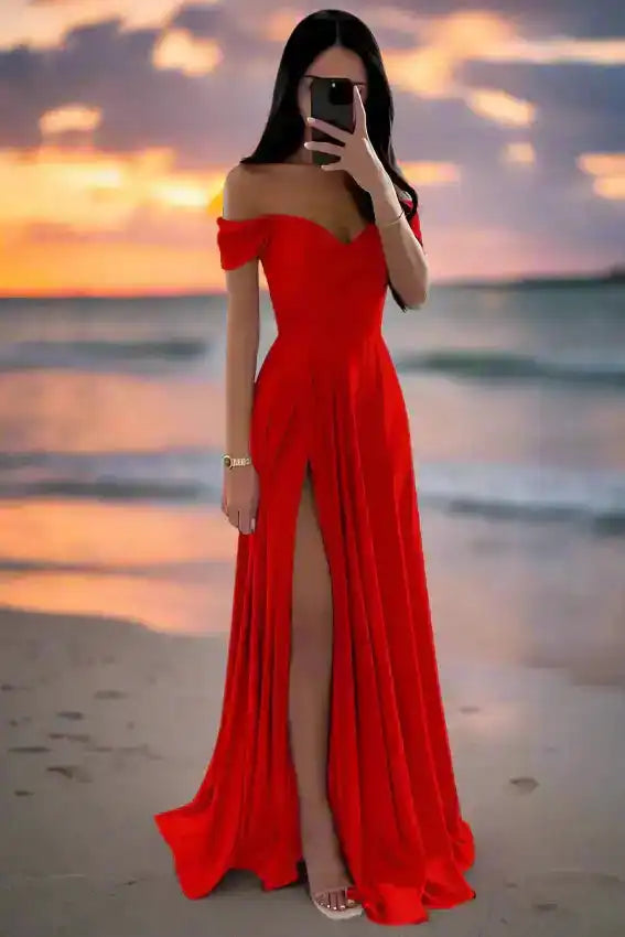 Bright red off shoulder satin gown with pleated A-line silhouette and high slit, ideal for beach weddings or formal occasions.