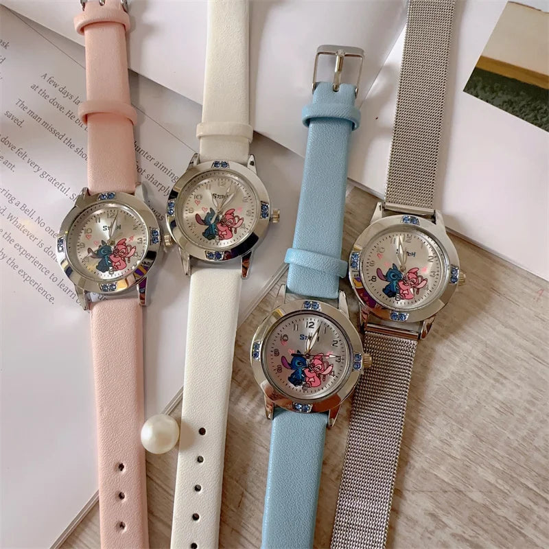 Four watches with different colored straps on a surface.