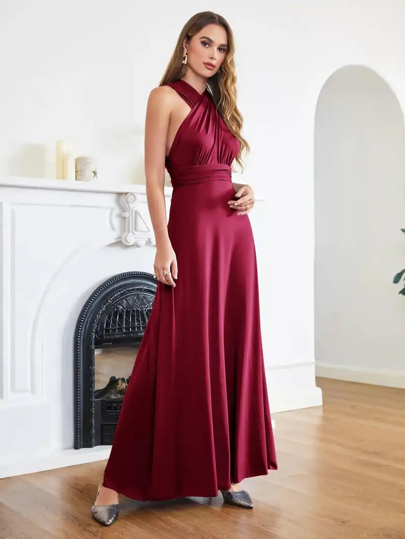 Bridesmaid Dress - Convertible Gown in burgundy by BABYONLINE, featuring a sleeveless halter V-neckline and floor-length multiway wrap design. Elegant and versatile formalwear for weddings or special events.