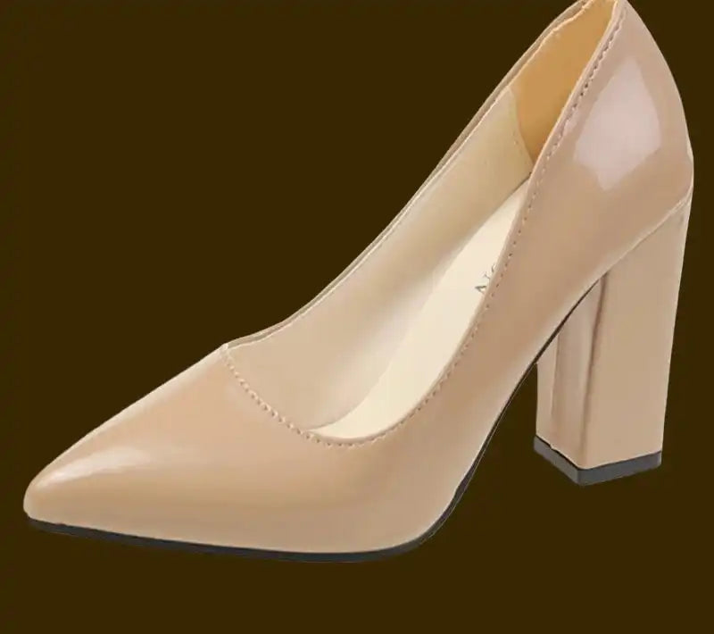 Beige high-heeled shoe on a dark brown background
