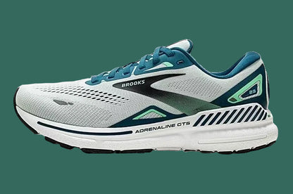 White and green running shoe with 'Brooks' branding on a white background