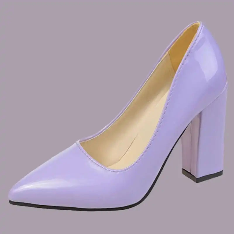 Purple high-heeled shoe on a gray background