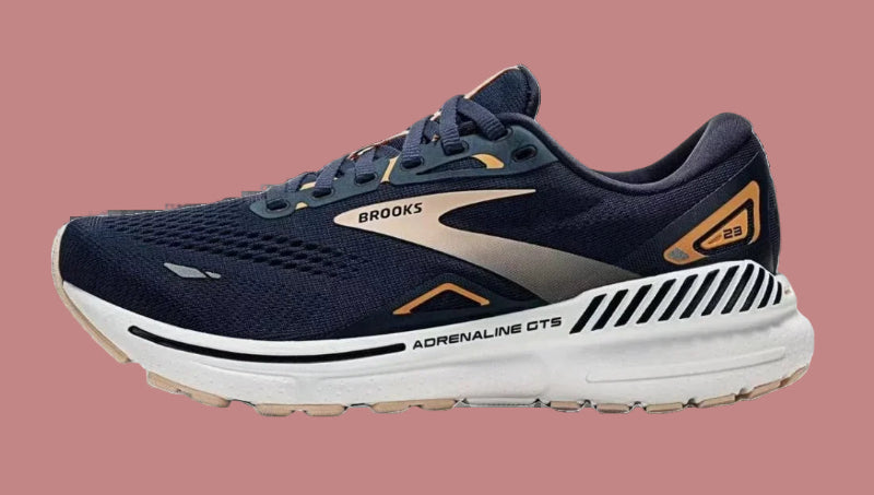 Navy running shoe with white sole on a white background